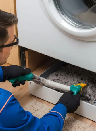 Technician performing dryer duct cleaning