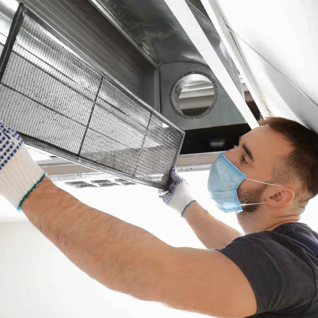 Technician performing residential air duct cleaning in Tampa home