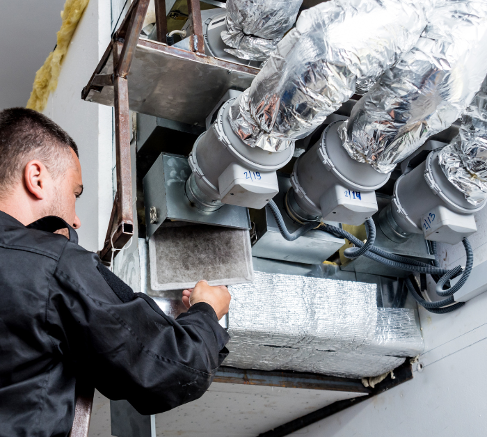 Technician performing air duct cleaning in Mango, FL home
