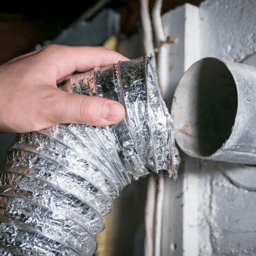 Technician inspecting dryer vent system in Tampa