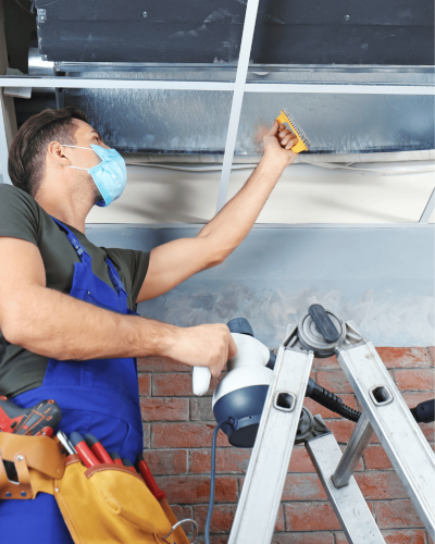 Technician performing professional air duct cleaning service