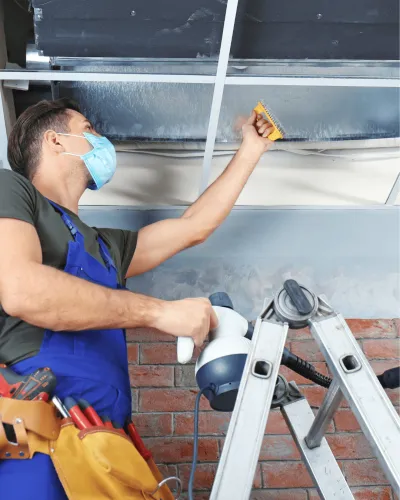 Technician performing professional air duct cleaning service